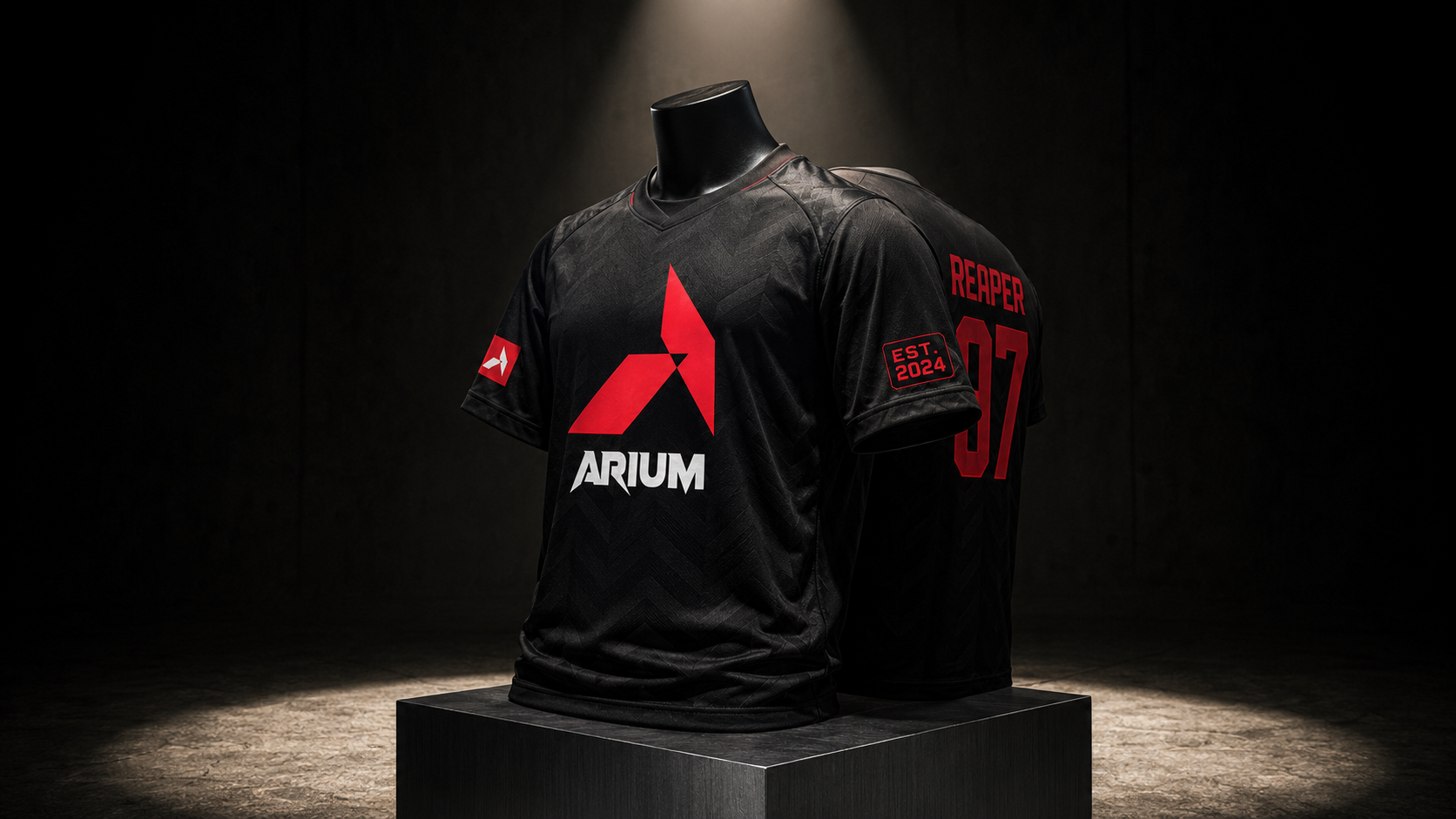 ARIUM official team jersey hero — premium technical knit on a matte-black headless mannequin, red chevron + ARIUM wordmark on chest, sleeve patches with chevron and EST date, REAPER 07 player name on shoulder, single hard spot in a dark drop room
