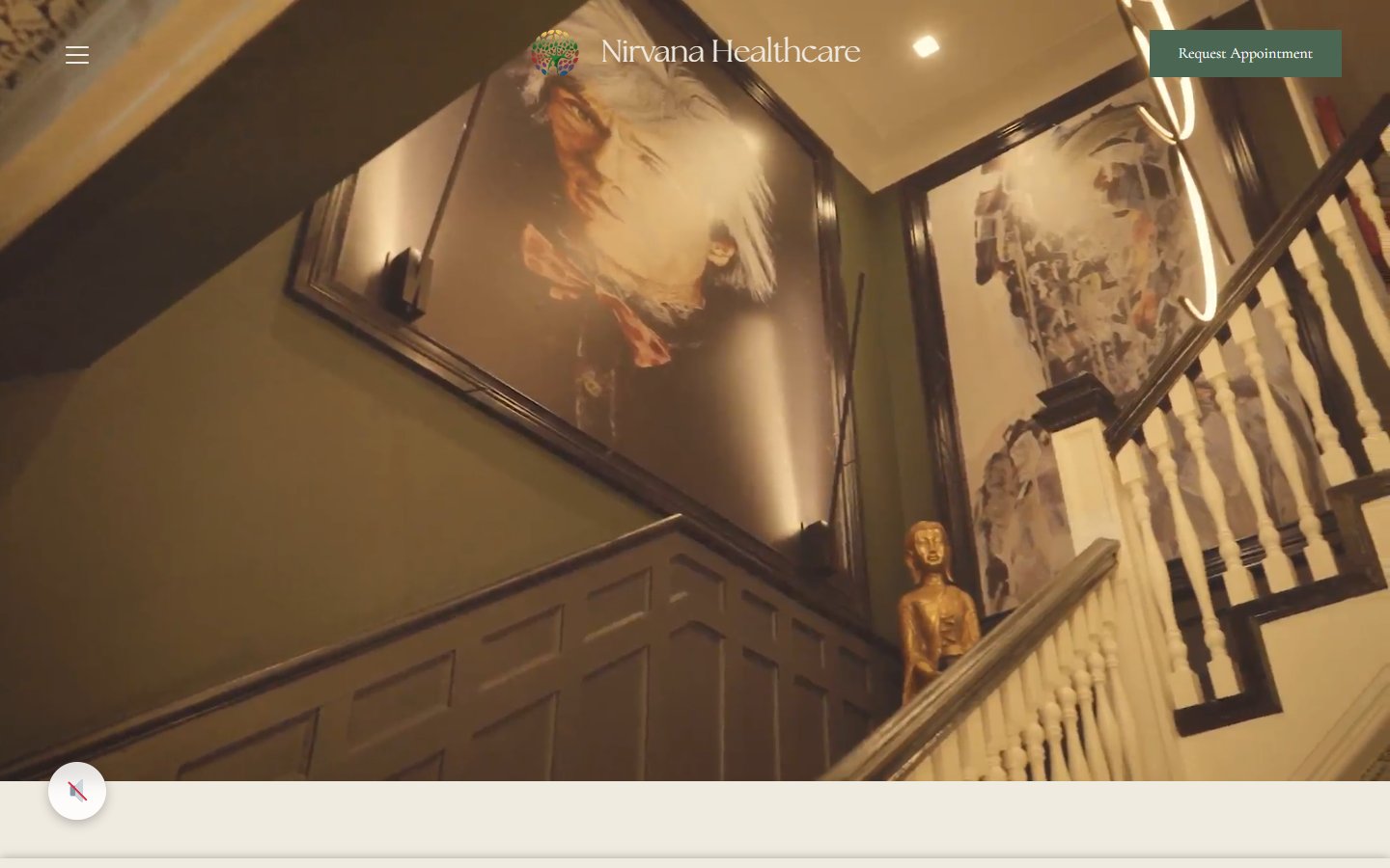 Deployed Nirvana Healthcare homepage in the browser, Victorian staircase hero with framed sepia doctor portraits and green Request Appointment button