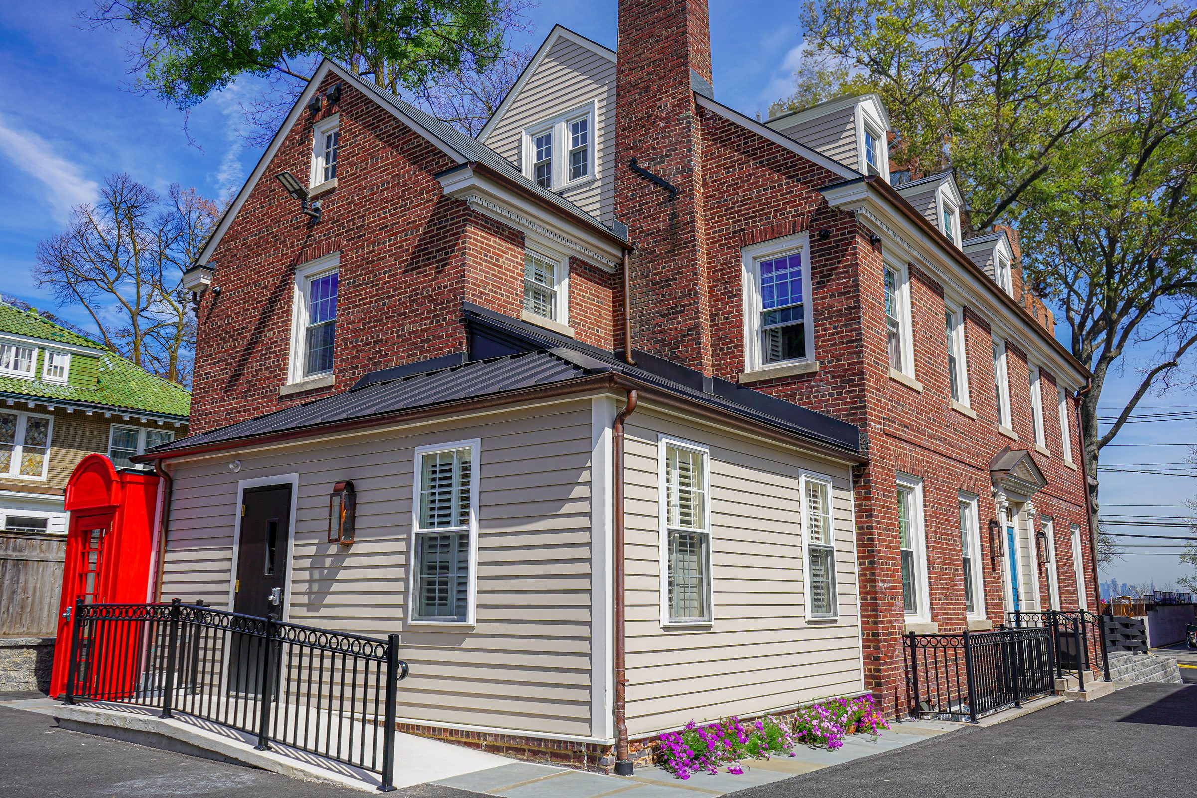Brick clinic exterior with Nirvana Healthcare signage and a red phone booth, photographed on location