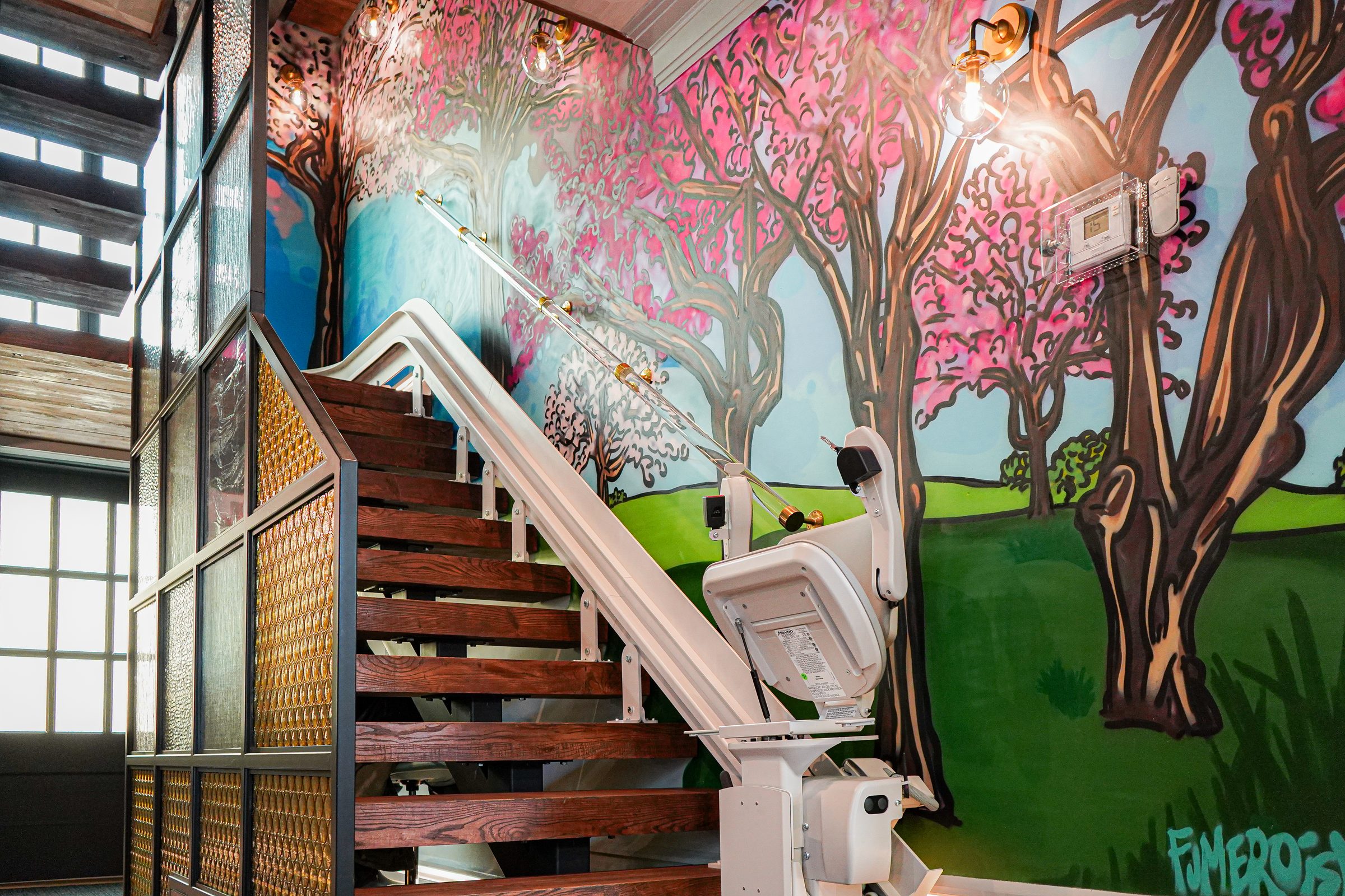Cherry blossom mural along a clinic staircase, photographed on location